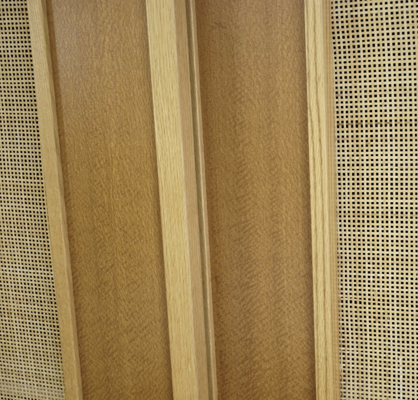 Detail of Sliding Closet Doors in red oak, Australian lacewood with woven cane panels.