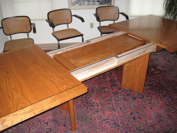 Dining Table;modern; extendible; leaf storage: cherry wood, curly cherry veneer, ebony inlay.