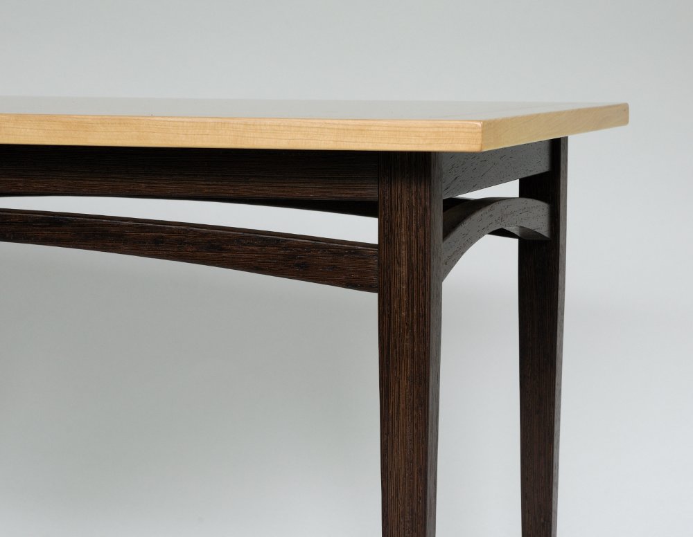 Table Detail: wenge and cherry wood, cherry veneer, ebony inlay.